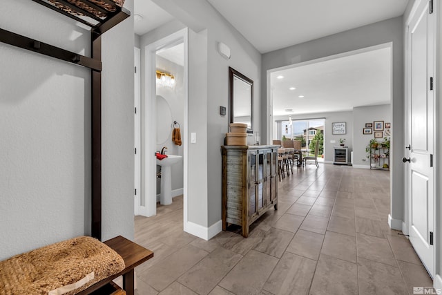 corridor featuring baseboards and recessed lighting