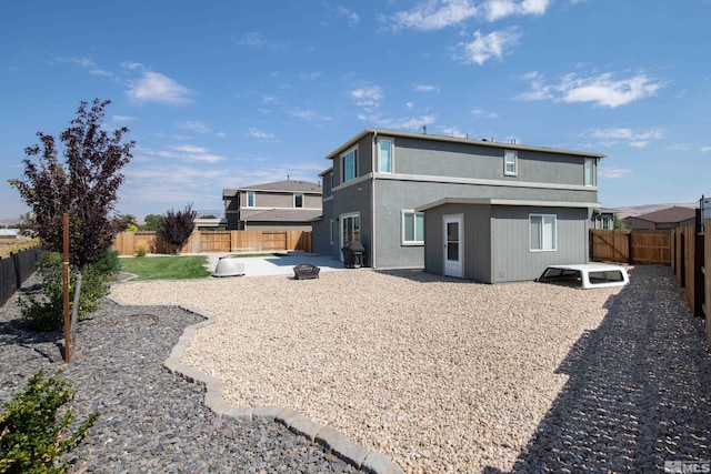 rear view of property with a patio and a fenced backyard