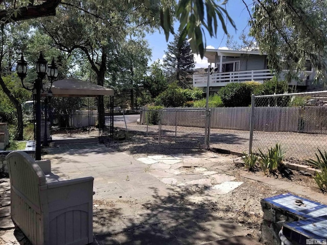 view of patio / terrace with a gate, fence, and a gazebo