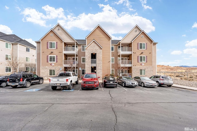 view of property featuring uncovered parking