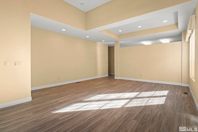 empty room with recessed lighting, visible vents, baseboards, and wood finished floors