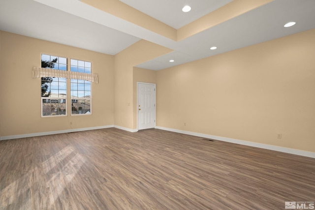 unfurnished room featuring recessed lighting, wood finished floors, and baseboards