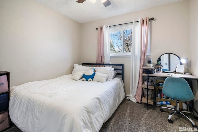 bedroom featuring a textured ceiling, dark colored carpet, and ceiling fan