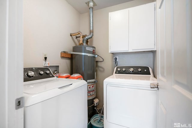 laundry room featuring cabinet space, water heater, and washer and dryer