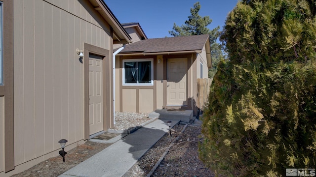 view of exterior entry featuring fence