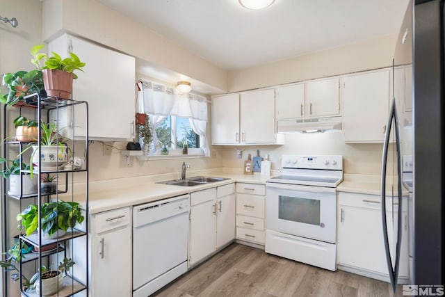 kitchen with light countertops, white cabinetry, a sink, white appliances, and under cabinet range hood