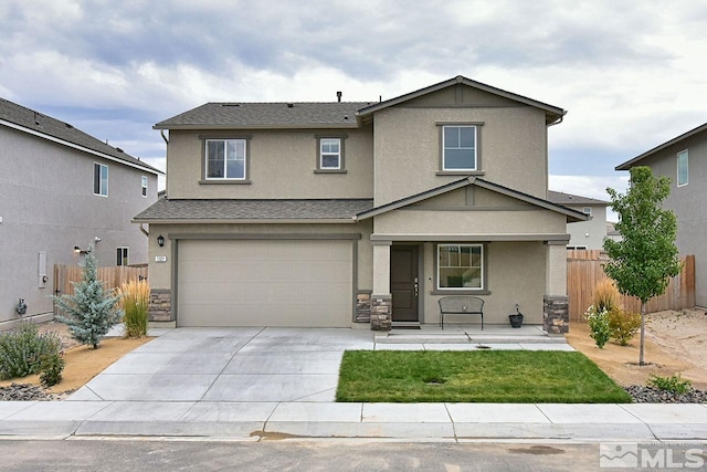 traditional home featuring a garage, fence, driveway, and stucco siding