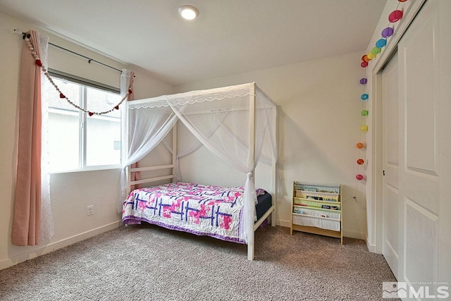 bedroom featuring carpet and baseboards