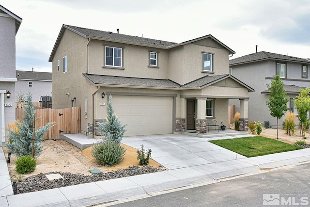 traditional-style house featuring driveway, a garage, fence, a porch, and stucco siding