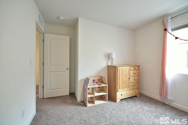 unfurnished bedroom featuring light colored carpet, visible vents, and baseboards