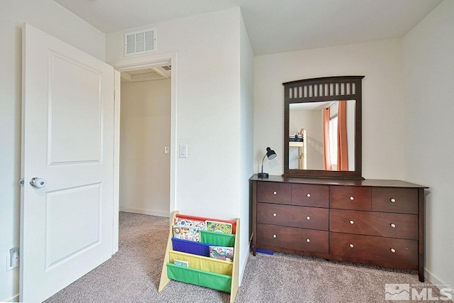 carpeted bedroom with baseboards and visible vents