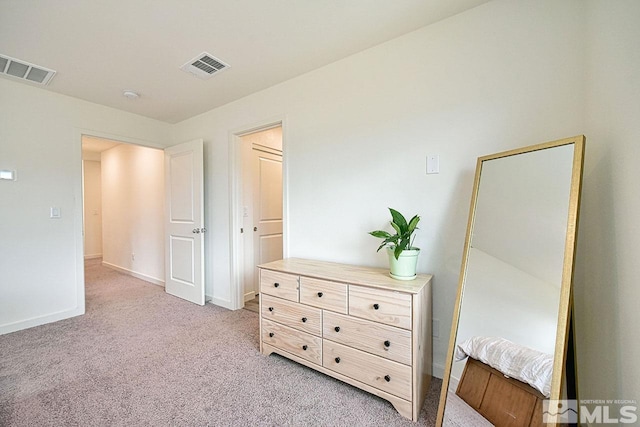 bedroom featuring light carpet, visible vents, and baseboards