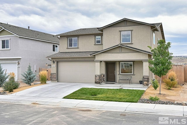 traditional-style house with a garage, a shingled roof, fence, driveway, and stucco siding