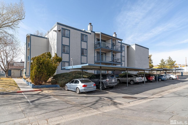 view of property featuring covered parking