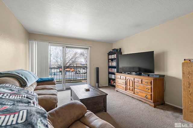 carpeted living room featuring a textured ceiling and baseboards