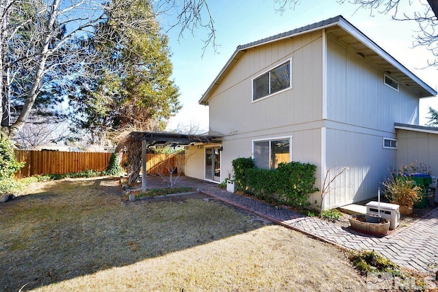 back of house featuring a patio area, fence, and a lawn