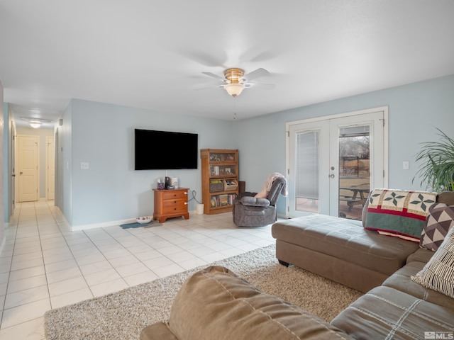 living area featuring light tile patterned floors, french doors, a ceiling fan, and baseboards