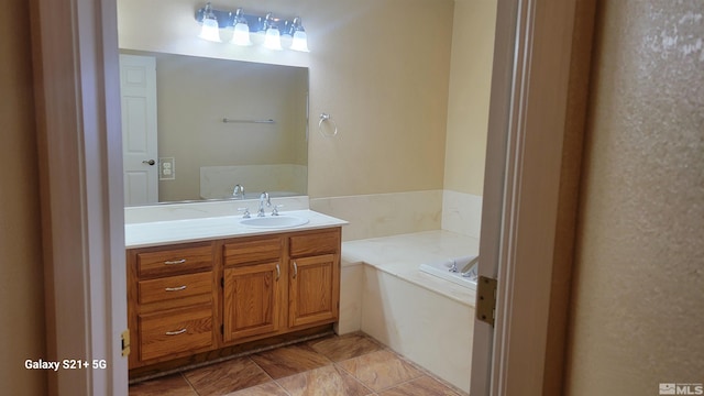 bathroom with a garden tub and vanity