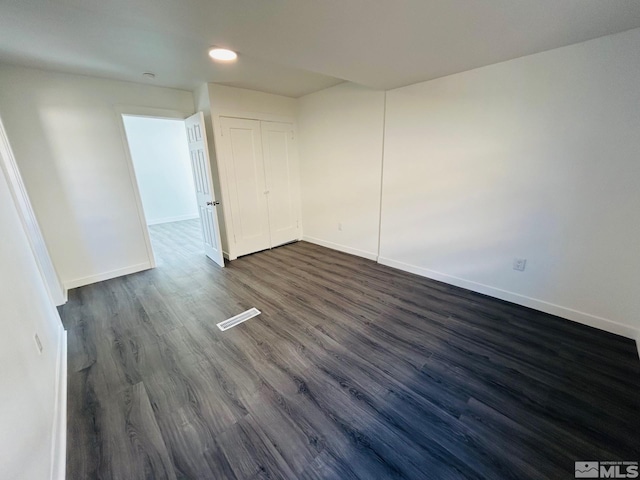 unfurnished room with baseboards, dark wood-style flooring, and recessed lighting