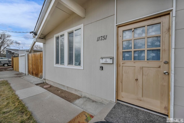 doorway to property with fence