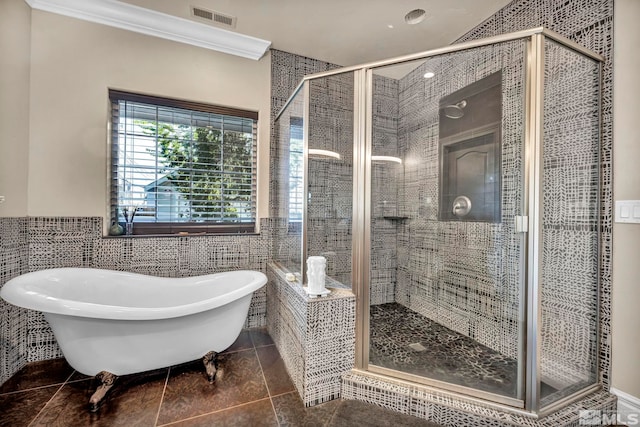 bathroom with a stall shower, visible vents, a soaking tub, ornamental molding, and tile patterned flooring