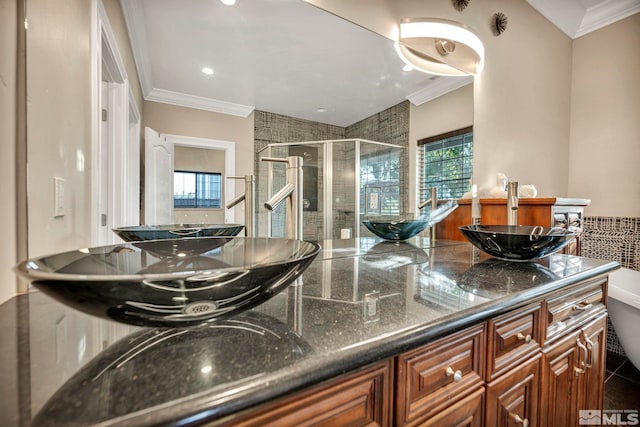 interior space featuring double vanity, recessed lighting, ornamental molding, a sink, and a shower stall