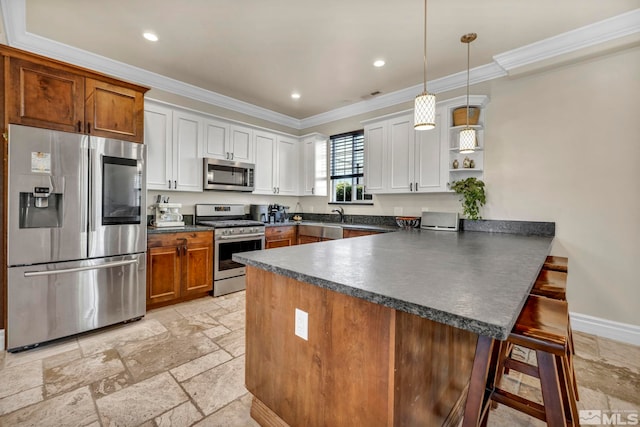 kitchen featuring stainless steel appliances, a breakfast bar, white cabinetry, and a peninsula