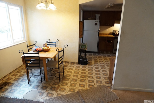 dining area featuring a chandelier