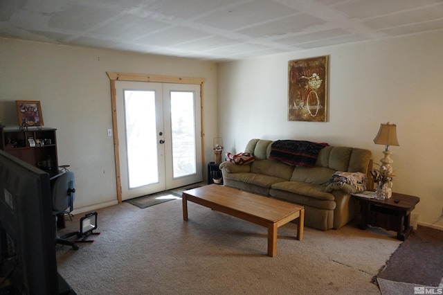 living room featuring baseboards, light colored carpet, and french doors