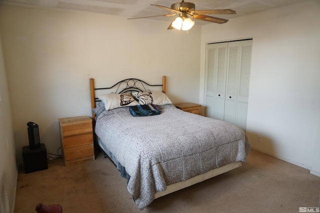 bedroom featuring carpet floors, a closet, and a ceiling fan