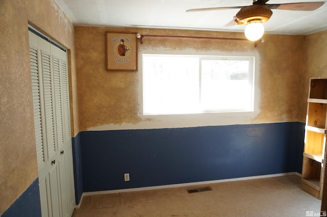 unfurnished bedroom with carpet floors, a closet, visible vents, and baseboards