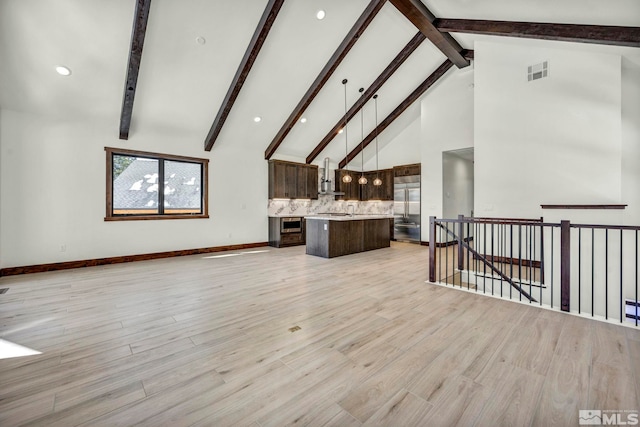 living room featuring high vaulted ceiling, light wood-type flooring, visible vents, and beamed ceiling