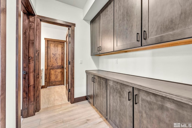 interior space with light wood-style flooring and baseboards