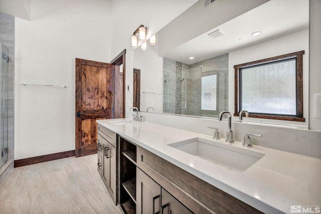 full bathroom with double vanity, a stall shower, a sink, and visible vents