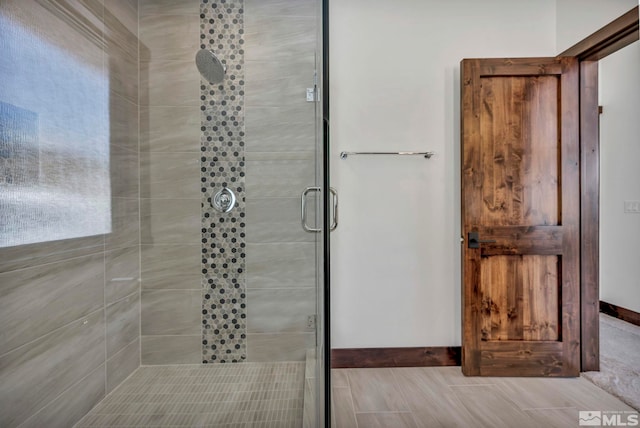 full bath with a stall shower and baseboards