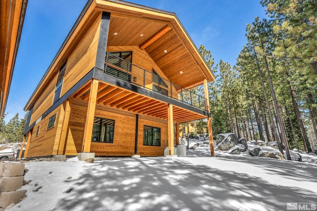 view of snowy exterior with a balcony