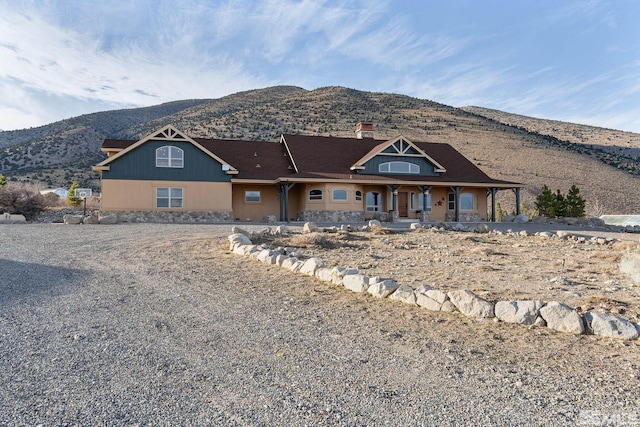 view of front facade featuring a mountain view and a chimney