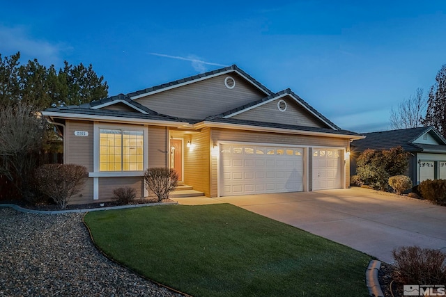 single story home featuring driveway, a garage, and a yard