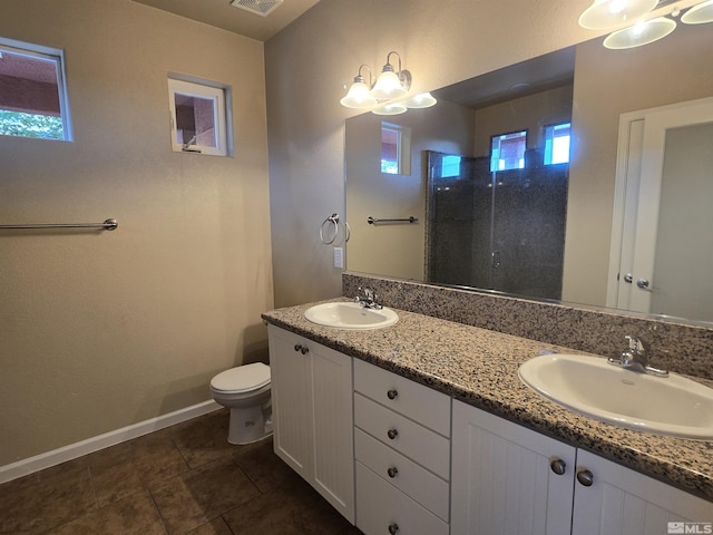 bathroom with visible vents, a sink, a tile shower, and double vanity