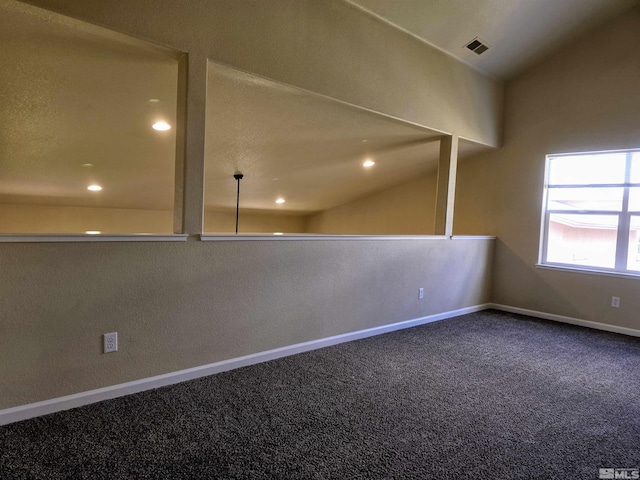 carpeted empty room with vaulted ceiling, recessed lighting, visible vents, and baseboards