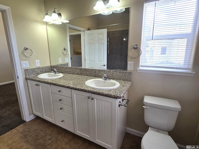 full bathroom with a wealth of natural light, a sink, and toilet