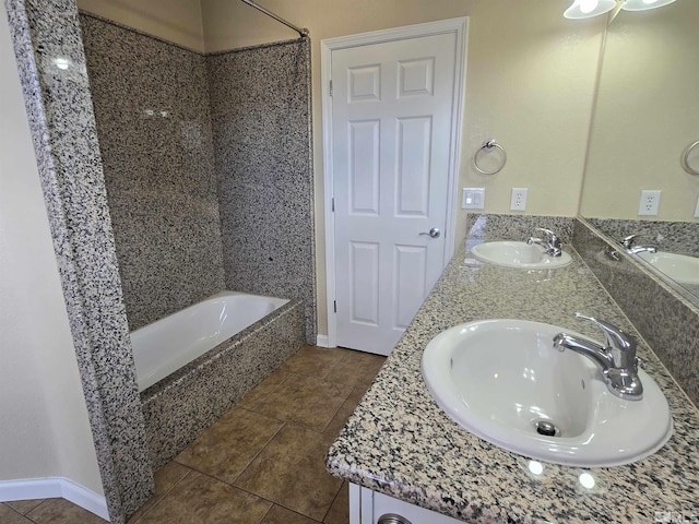 full bathroom featuring double vanity, a sink, and tile patterned floors