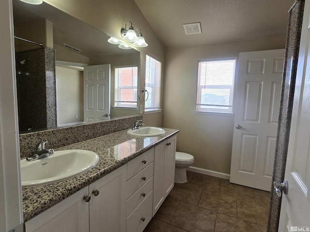 bathroom with visible vents, a sink, and tile patterned floors