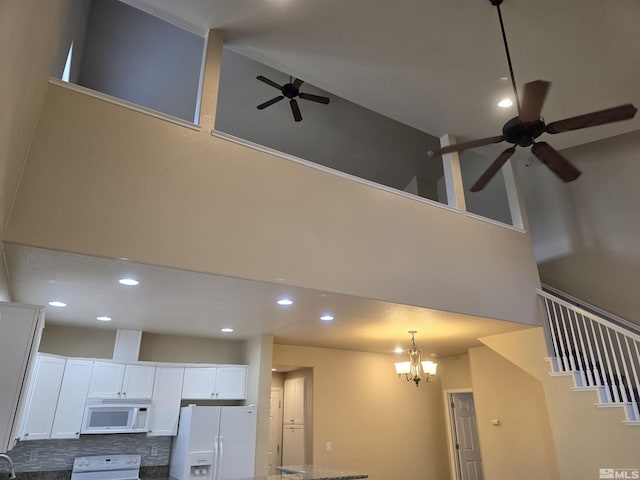 room details featuring ceiling fan with notable chandelier, white appliances, decorative backsplash, and recessed lighting