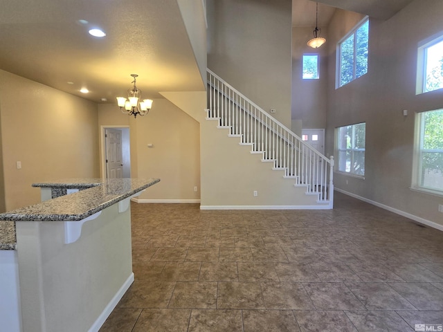 interior space featuring a healthy amount of sunlight, stairs, baseboards, and recessed lighting