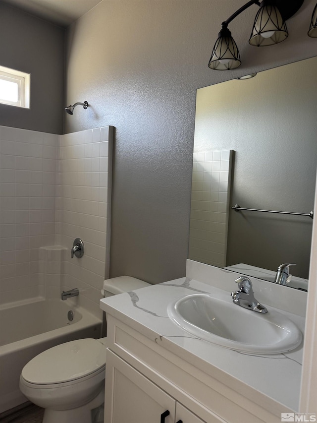 bathroom featuring vanity, toilet, and washtub / shower combination