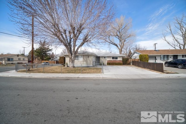 ranch-style home featuring a fenced front yard and a residential view