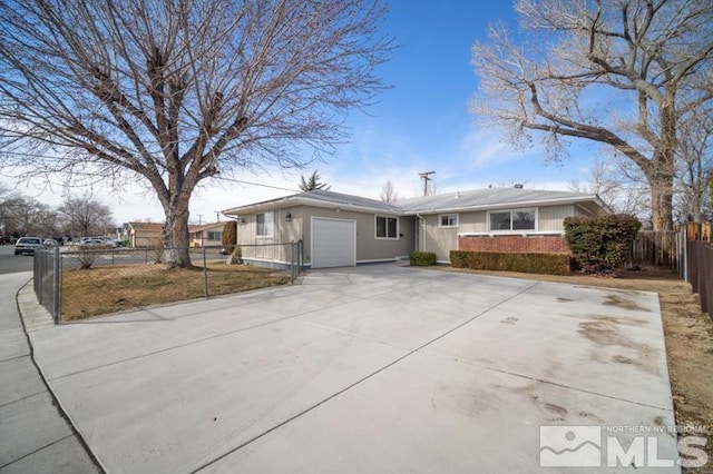 ranch-style home featuring driveway, a garage, fence, and brick siding