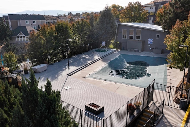 view of swimming pool featuring a residential view, fence, and a mountain view