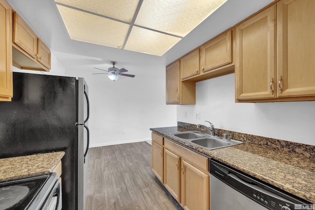 kitchen featuring ceiling fan, light brown cabinets, a sink, appliances with stainless steel finishes, and light wood finished floors